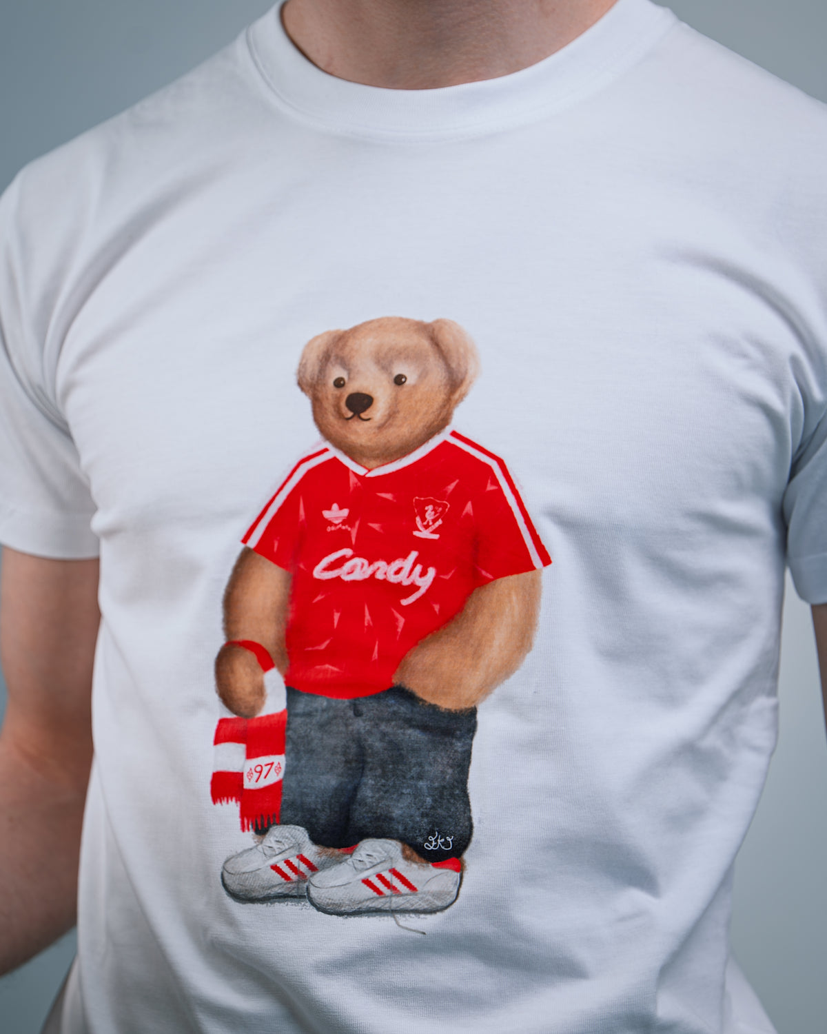 White t-shirt with a bear wearing a red shirt 