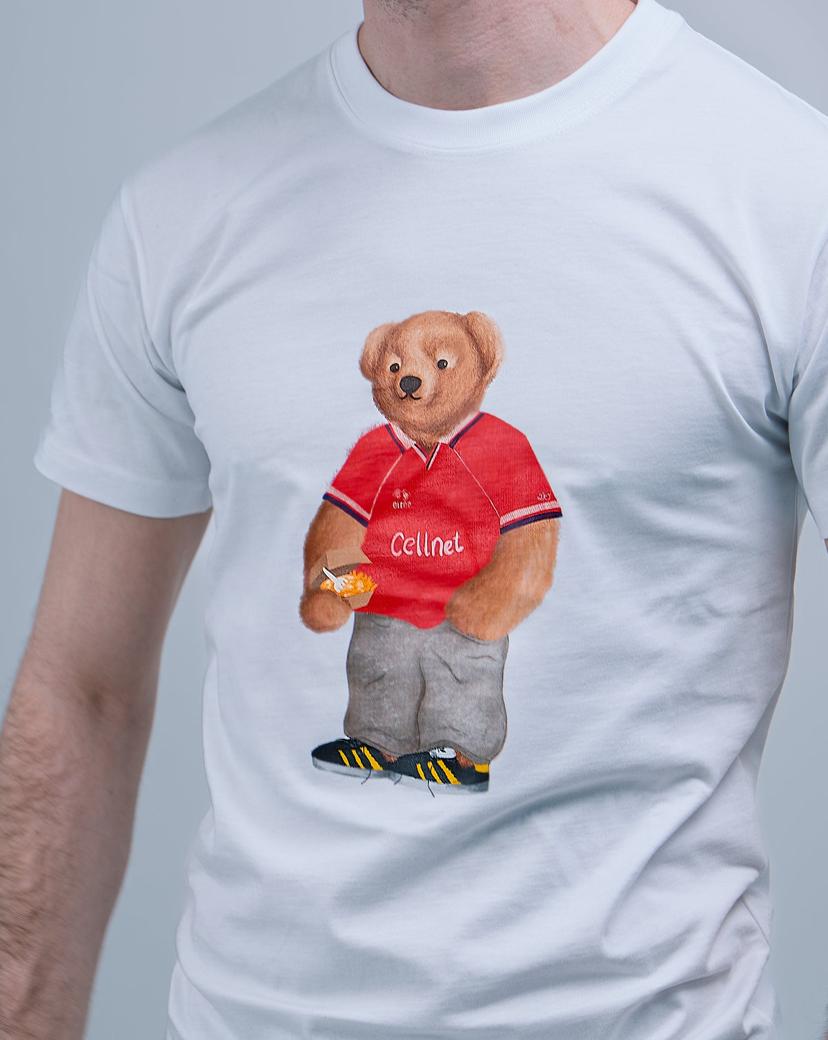 White t-shirt with a bear wearing a red shirt and 'Celine' logo on a gray background