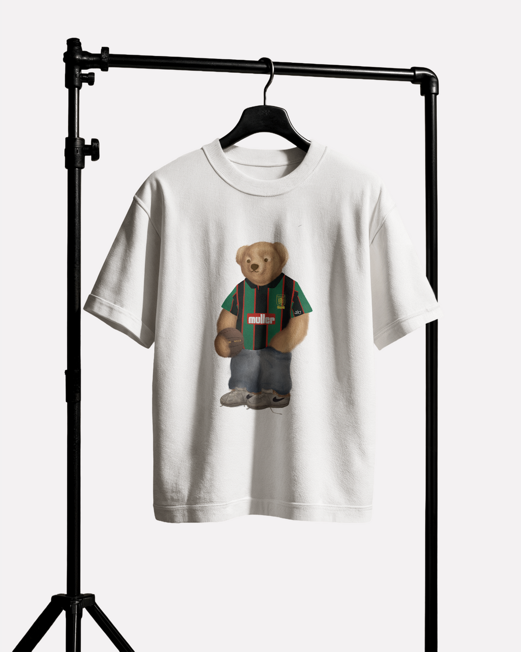 White t-shirt with a aston villa bear graphic on a black stand against a white background