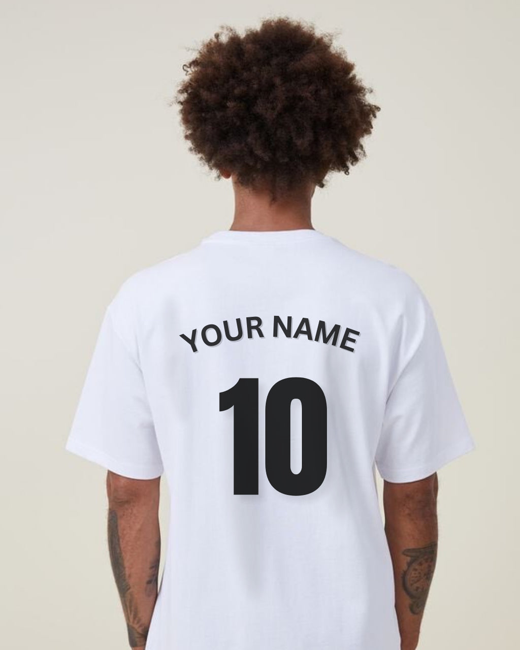White t-shirt with 'Your Name' and number '10' on the back, worn by a person.