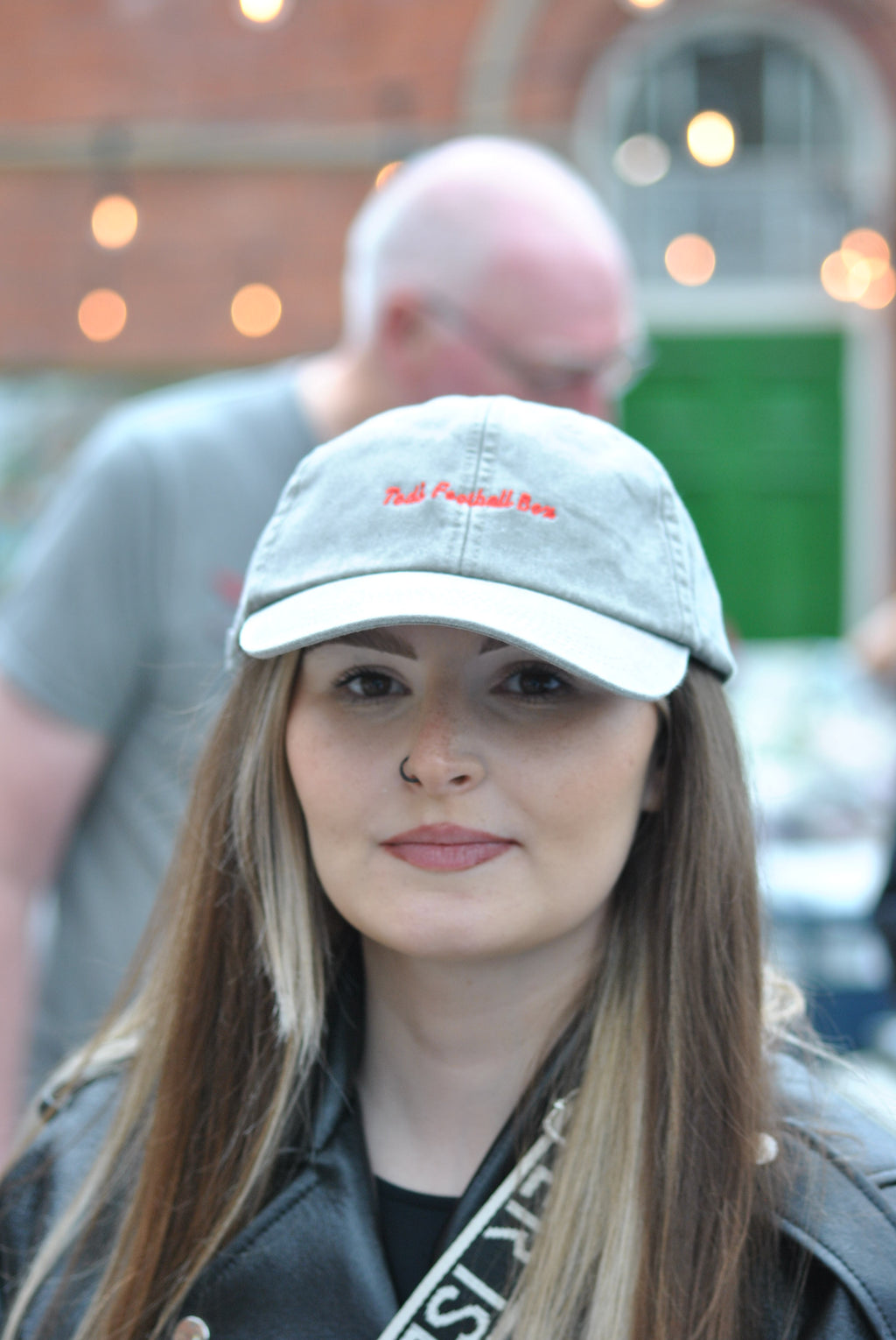 woman wearing a grey cap with a blurred background