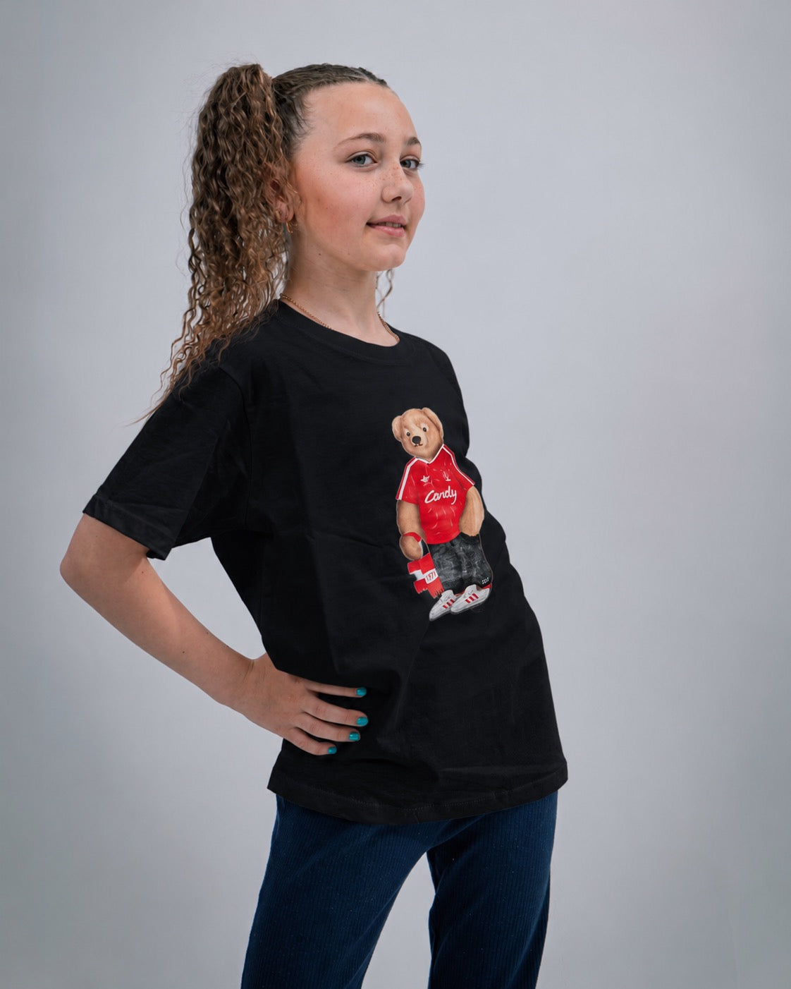 Girl wearing a black t-shirt with a graphic design on a gray background
