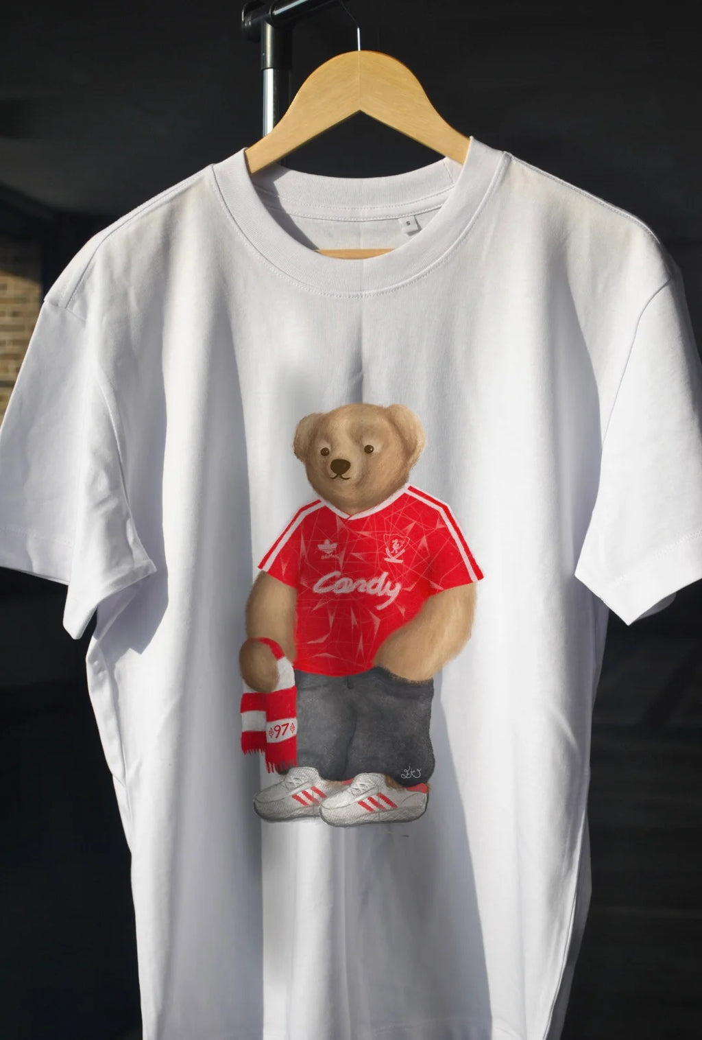 White t-shirt with a bear wearing a red shirt 