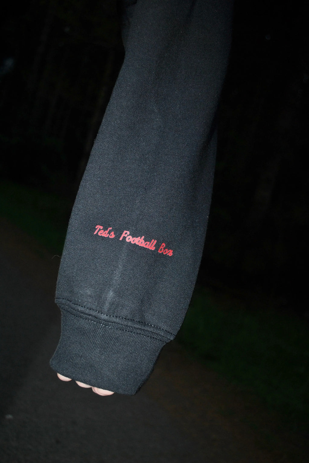 Dark blue sweatshirt with red text on a black background