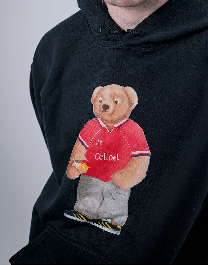 Black hoodie with a bear wearing a red shirt and 'Cellinel' logo on a gray background