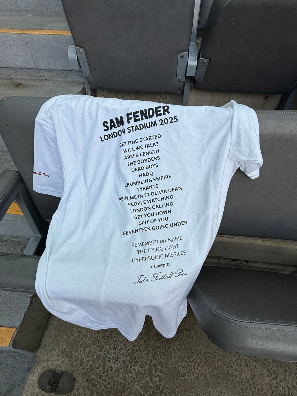 White t-shirt with set list on a chair