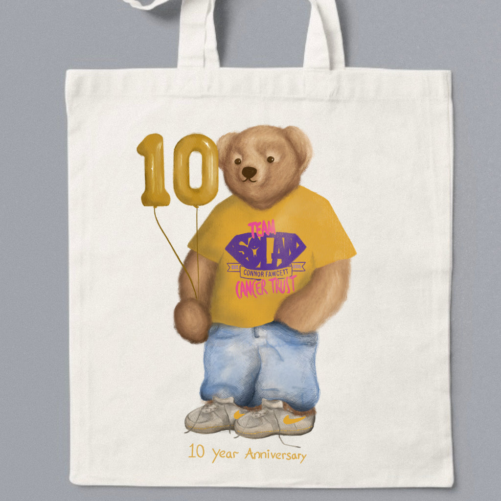 Tote bag with a bear holding balloons and a t-shirt, featuring '10 Year Anniversary' text.
