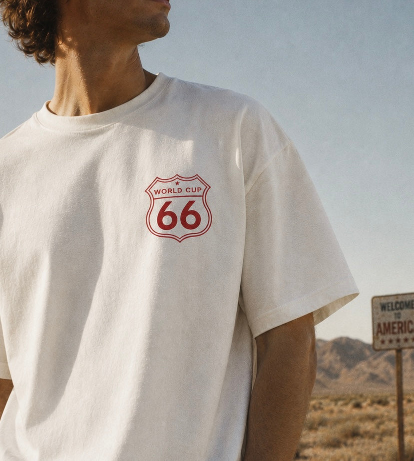 Person wearing a white t-shirt with a red logo in a desert setting